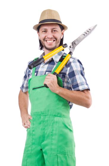 A man wearing a cowboy hat smiles while holding a large shear tool.